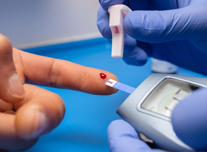 Closeup shot of a doctor with rubber gloves taking a blood test from a patient