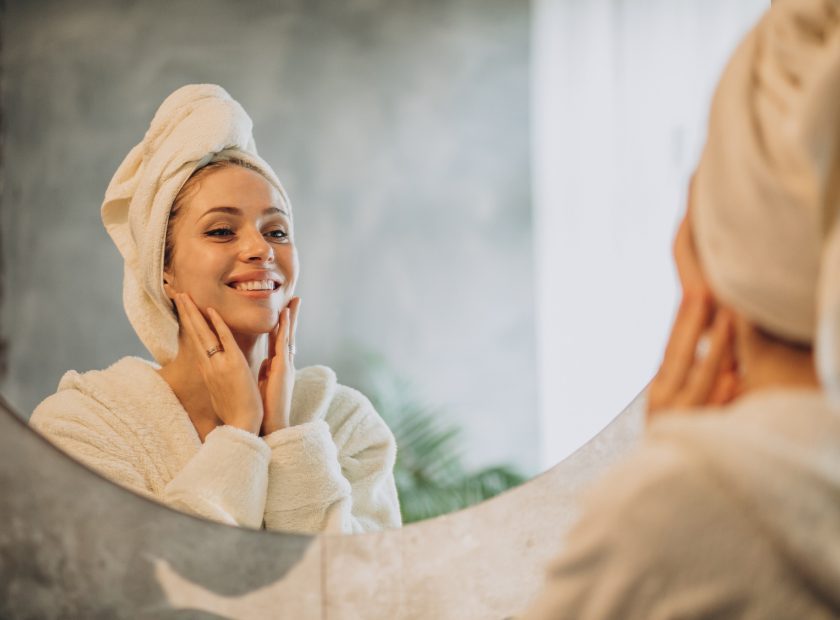 Woman at home applying cream mask