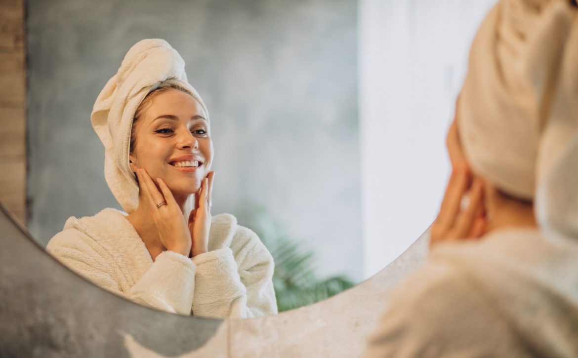 Woman at home applying cream mask